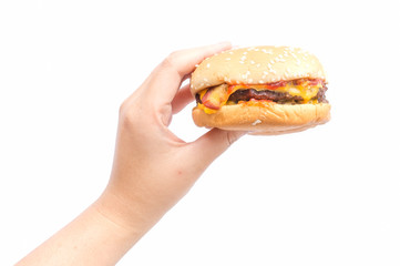 Female hand holding burger in isolate background.