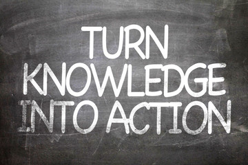 Fototapeta premium Turn Knowledge into Action written on a chalkboard