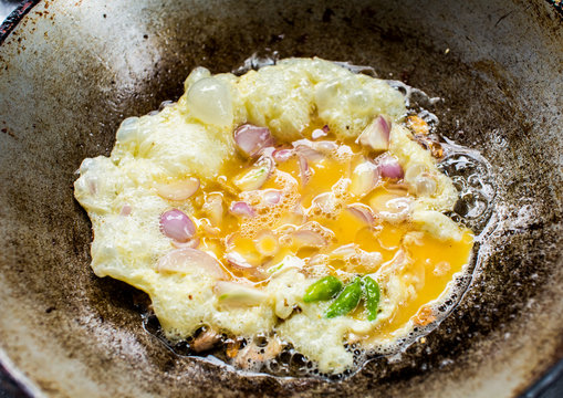 frying omelet in pan