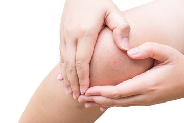 Woman hand touch on pain knee with isolated background.