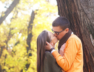 Fototapeta premium Cheerful young couple enjoy break on sunny autumn day in park