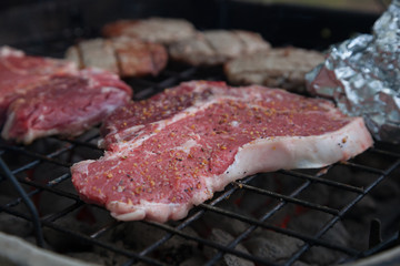 T-Bone Steaks being grilled on Charcoal Grill