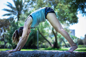 Young woman doing yoga in morning park