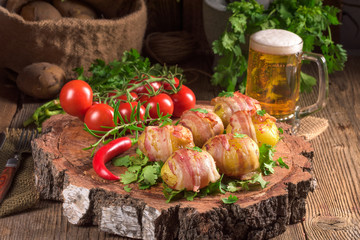 Baked potatoes wrapped in ham