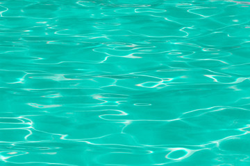 green pool water with sun reflections