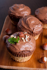 Chocolate muffins with nuts, decorated with mint