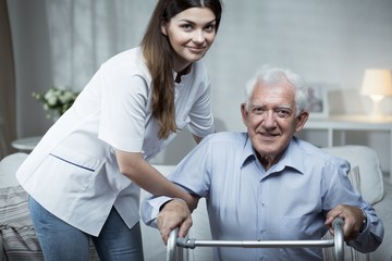 Nurse helping disabled senior man