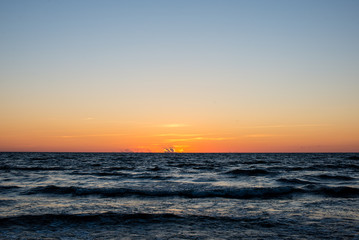 Fototapeta na wymiar red dramatic sunset on the sea beach
