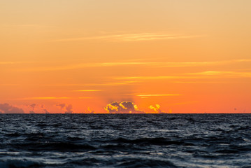 red dramatic sunset on the sea beach