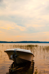 Obraz premium Evening landscape at the lake with the boat
