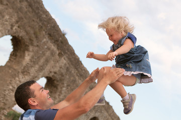 Fototapeta premium Happy family fun on field with haystacks