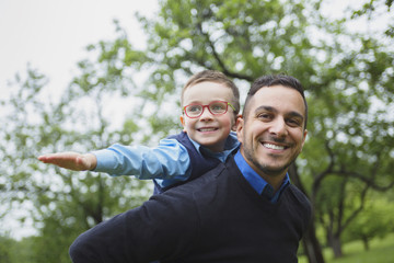 Father and son in forest on a meadow