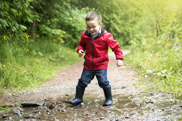 Portrait of cute little boy child outdoors on the nature