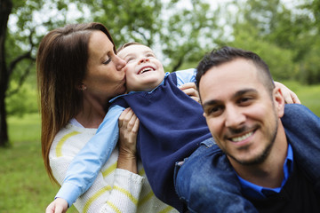 Fototapeta premium Father mother and son in forest having fun together