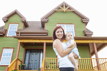 Mother and baby in front of the house