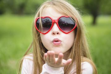 Adorable little girl in the forest meadow
