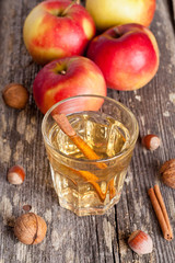 spiced apple cider and spices on a wooden table, close-up