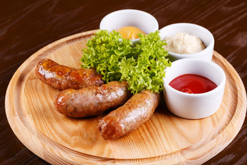 Grilled sausage with sausages on wooden board