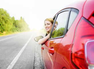 Woman in red car.