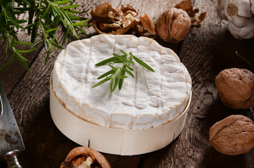 Camembert cheese on a rustic background