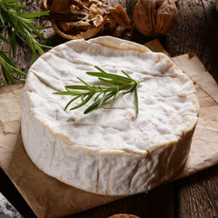 Camembert cheese on a rustic background