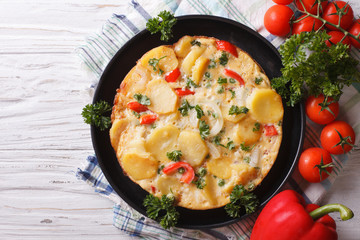 Spanish tortilla with potatoes on a plate. horizontal top view 
