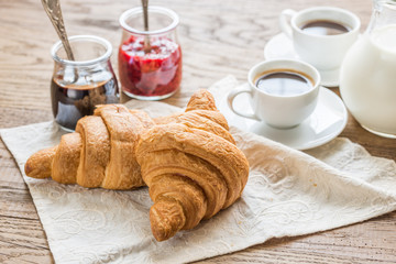 Croissants with  cups of coffee and milk