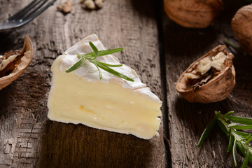 Camembert cheese on a rustic background