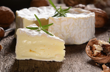 Fototapeta na wymiar Camembert cheese on a rustic background