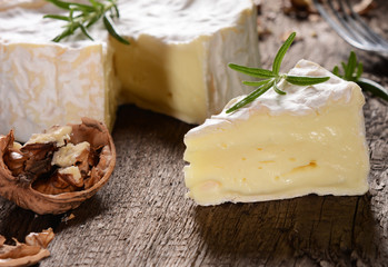 Camembert cheese on a rustic background