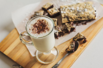 Milk cocktail with chocolate cookies on table close-up