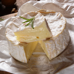 Camembert cheese on a rustic background
