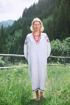 Blonde Woman In The Village  Barefoot On Green Grass