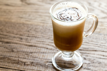 Glass mug with cappuccino