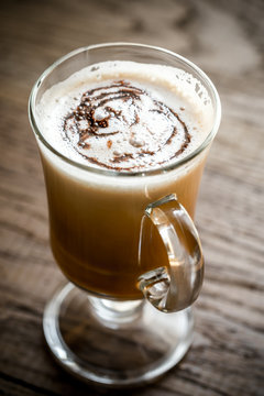 Glass mug with cappuccino