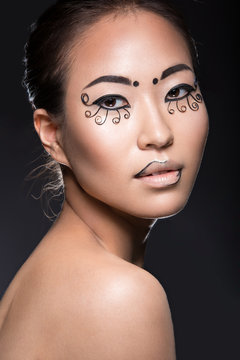 Beautiful Asian girl with a creative makeup, unusual eyelashes