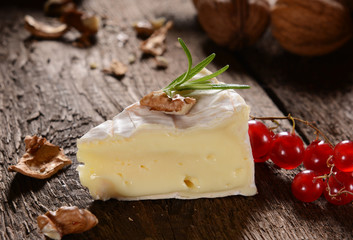 Camembert cheese on a rustic background
