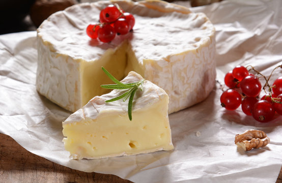 Camembert cheese on a rustic background