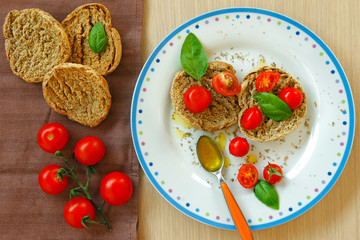 Apulian bread friselle with tomatoes, basil, olive oil, origan