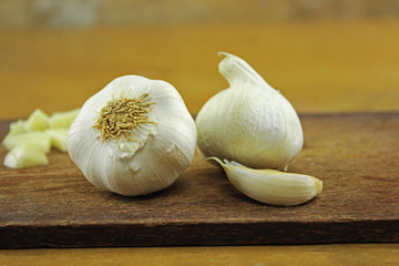 Knoblauch - Knollen, Zehe und zerhackt auf Küchenbrett mit Küchenmesser