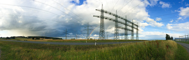 Energieerzeugung und Transport mit Regenbogen im Hintergrund