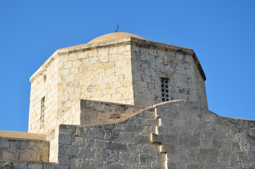 Fototapeta na wymiar Cypriot Orthodox church steeple stone in the blue sky of Cyprus.