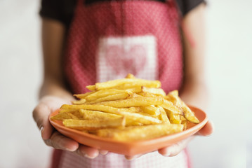 Woman holding Fried Potatoes 