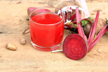 fresh vegetables beetroot juice and a tape measure