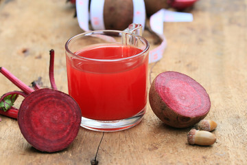 fresh vegetables beetroot juice and a tape measure