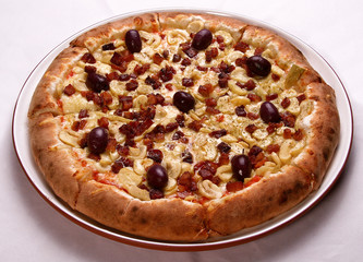 ham, mushroom and vegetable pizza and salami pizza at the back