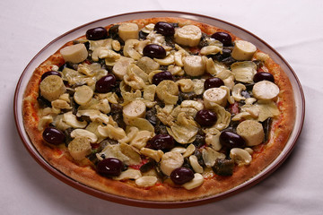 ham, mushroom and vegetable pizza and salami pizza at the back
