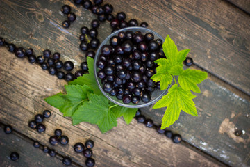 black currant in a glass bowl transparent scattered on the old w © allamaistrenko