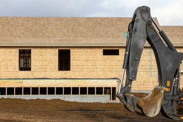 New home construction with an excavator arm