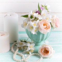 Fototapeta na wymiar Roses and jasmine flowers and candles